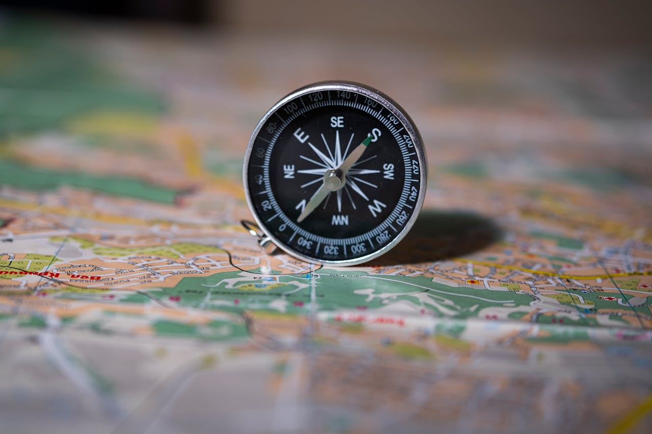 Me loome sisu Black compass on detailed map symbolizing navigation and exploration.