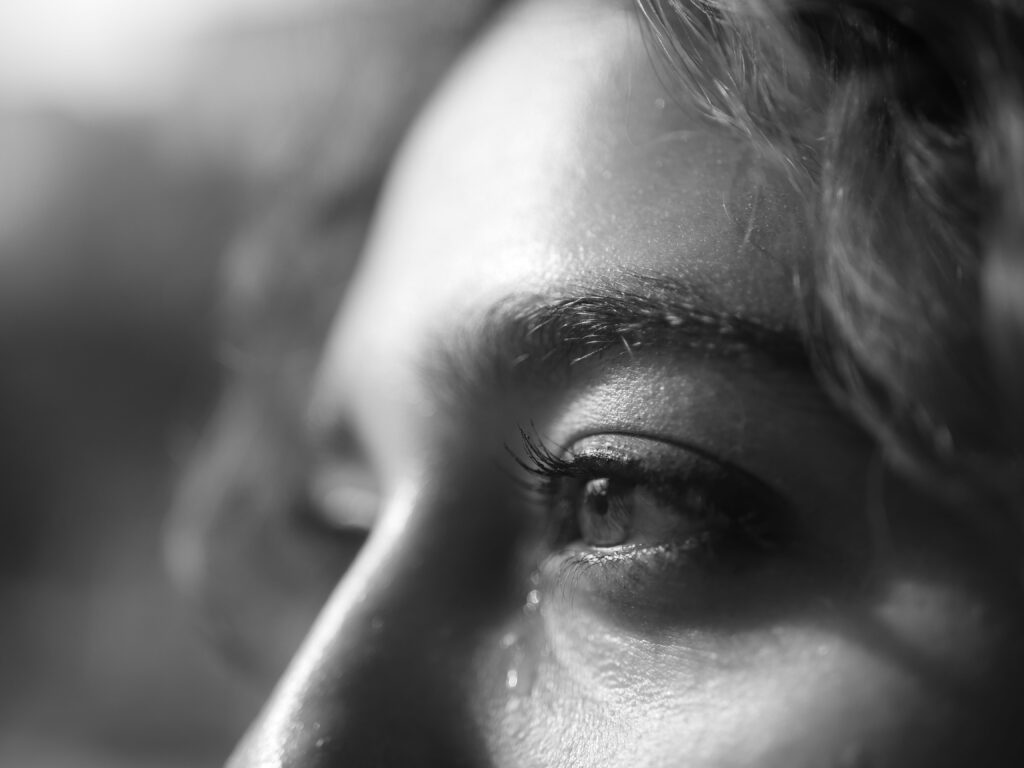 Millal on õige aeg? Black and white close-up of a human eye expressing emotion. Captures the essence of feelings.