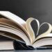 Lase vabaks see, mida sa enam ei valiks. Open book with pages forming a heart, symbolizing love for reading and literature.
