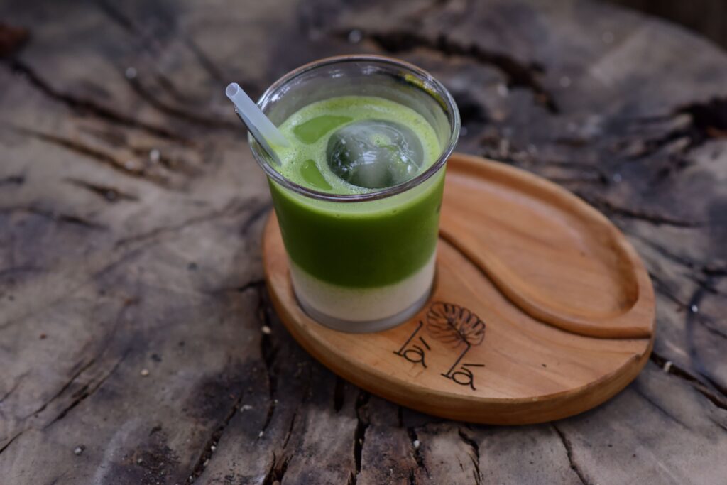 Ka kõige aeglasem kilpkonn jõuab kaldale Iced matcha latte with ice ball on rustic wooden tray, perfect for a refreshing break.