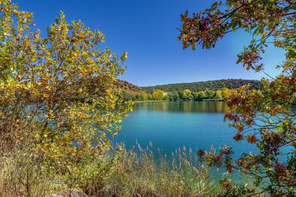 Beautiful autumn landscape of Ruidera Lakes in Castilla-La Mancha, with vibrant foliage.