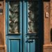 Charming vintage blue door with intricate ironwork in Balıkesir, Türkiye, showcasing classic architectural style.